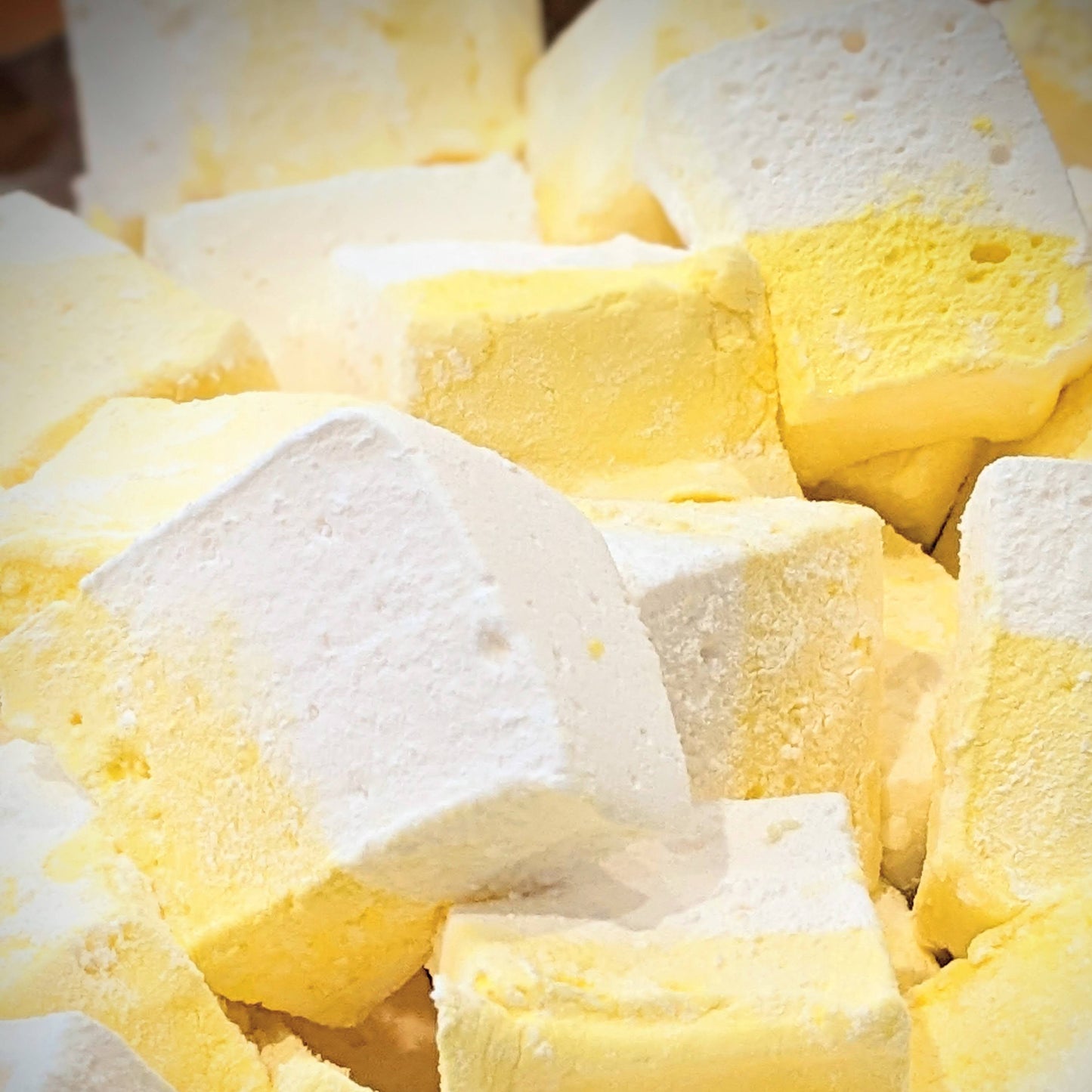 Pile of lemon meringue marshmallows, yellow and white, freshly cut