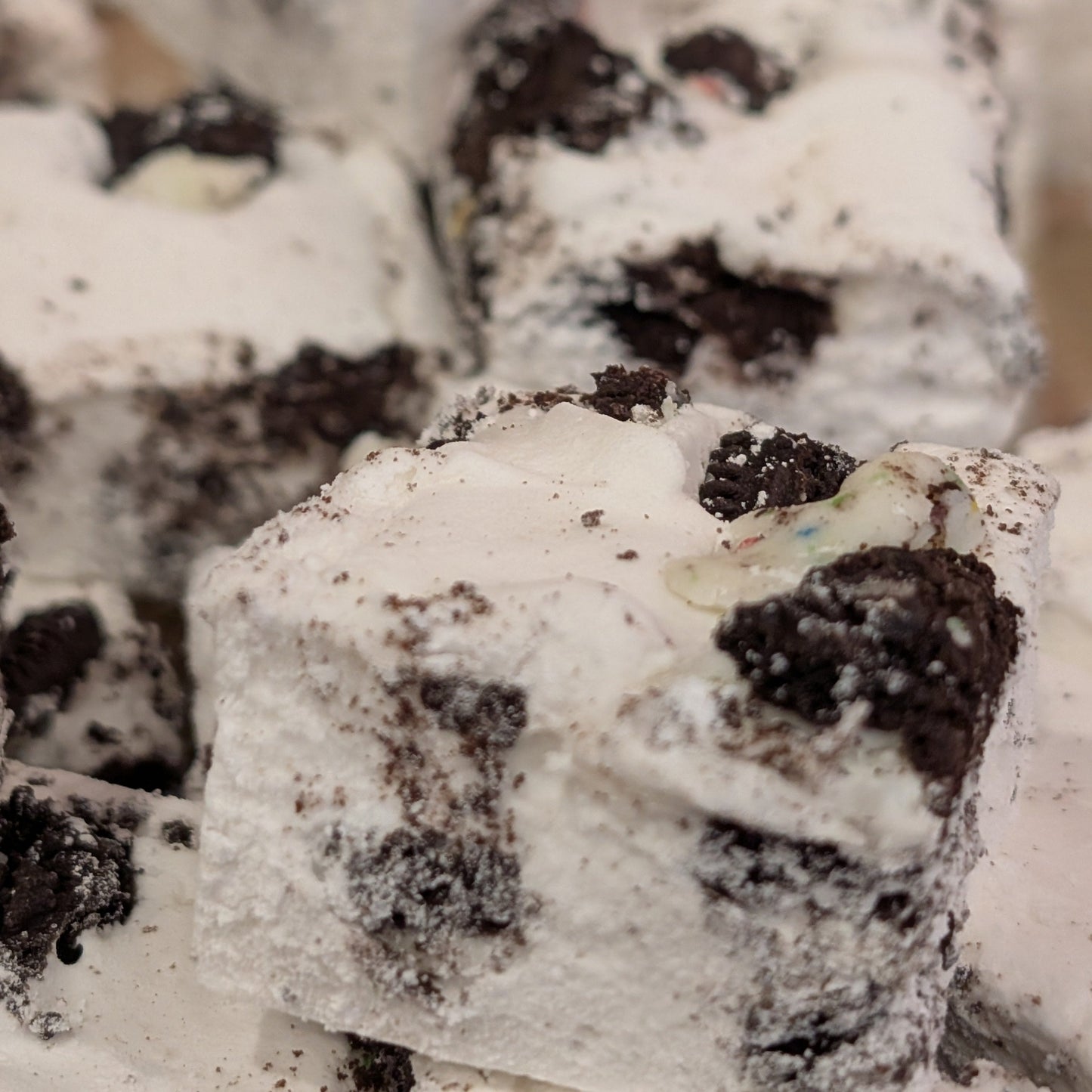 Close up of white marshmallow with chunks of birthday cake oreos mixed throughout.