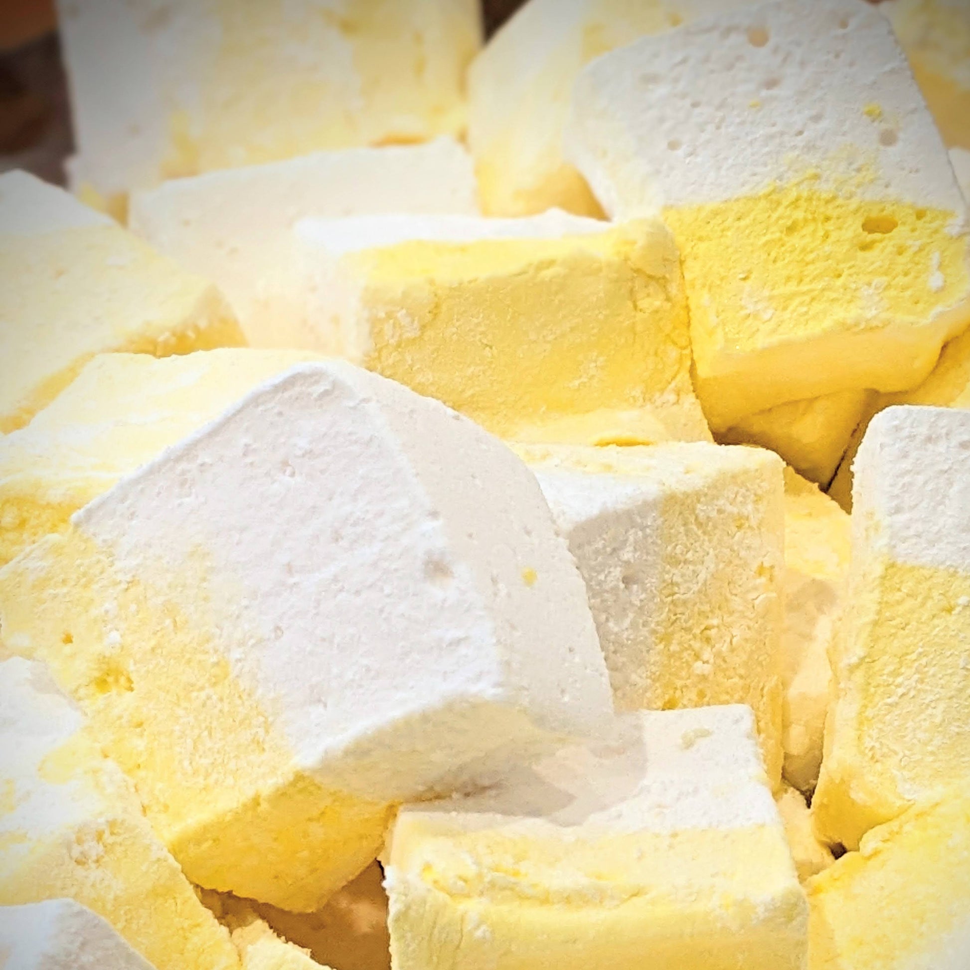Pile of lemon meringue marshmallows, yellow and white, freshly cut